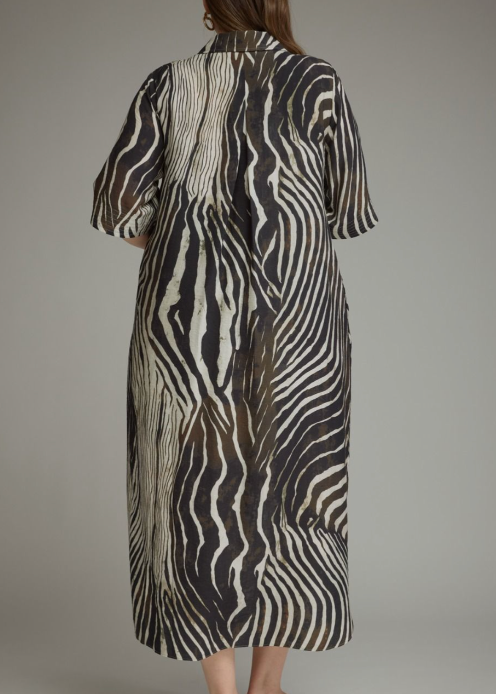 the back of a zebra print dress on a women