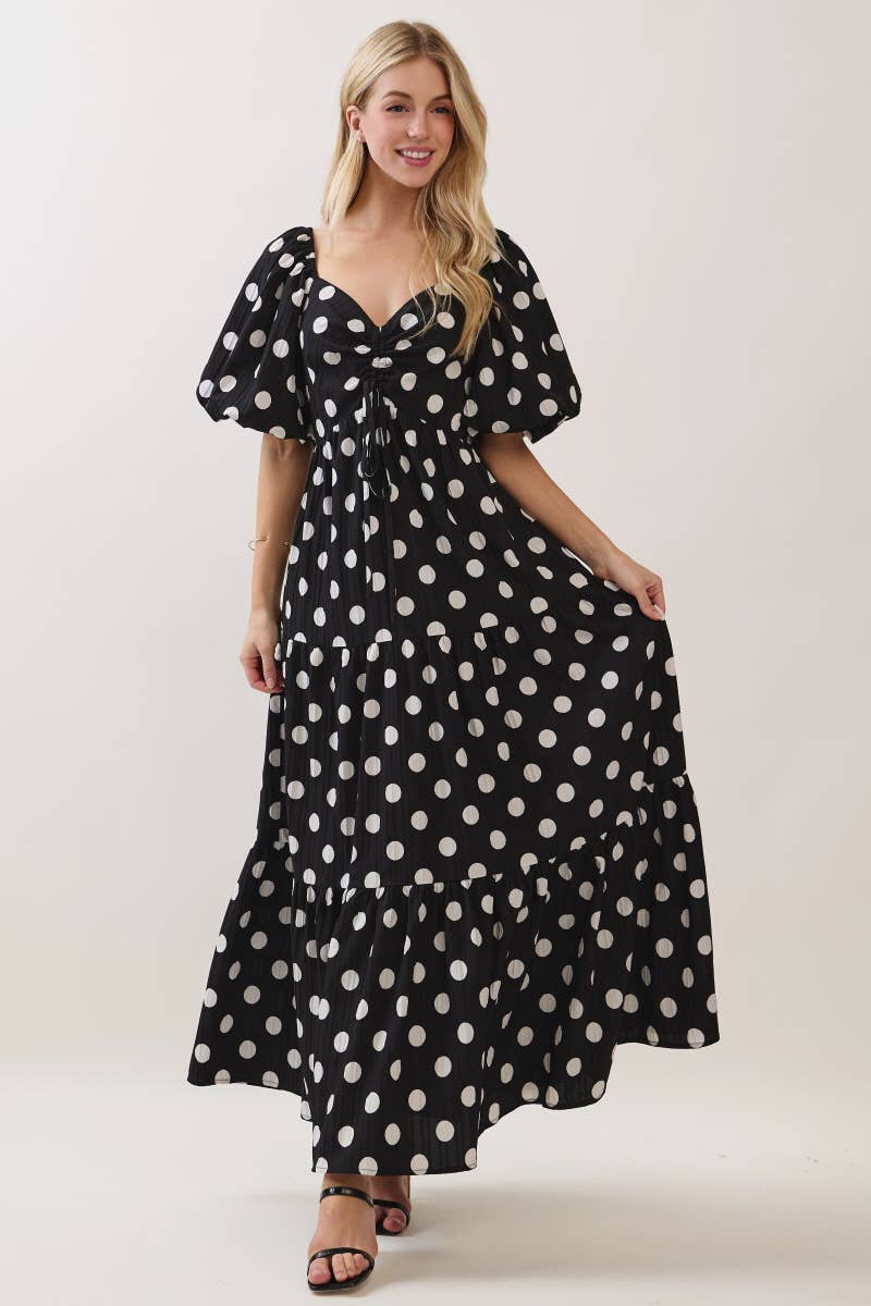 women wearing black with white polka dot maxi dress