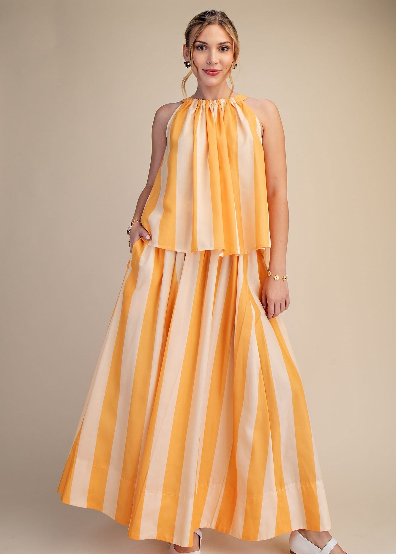 women wearing yellow striped maxi dress