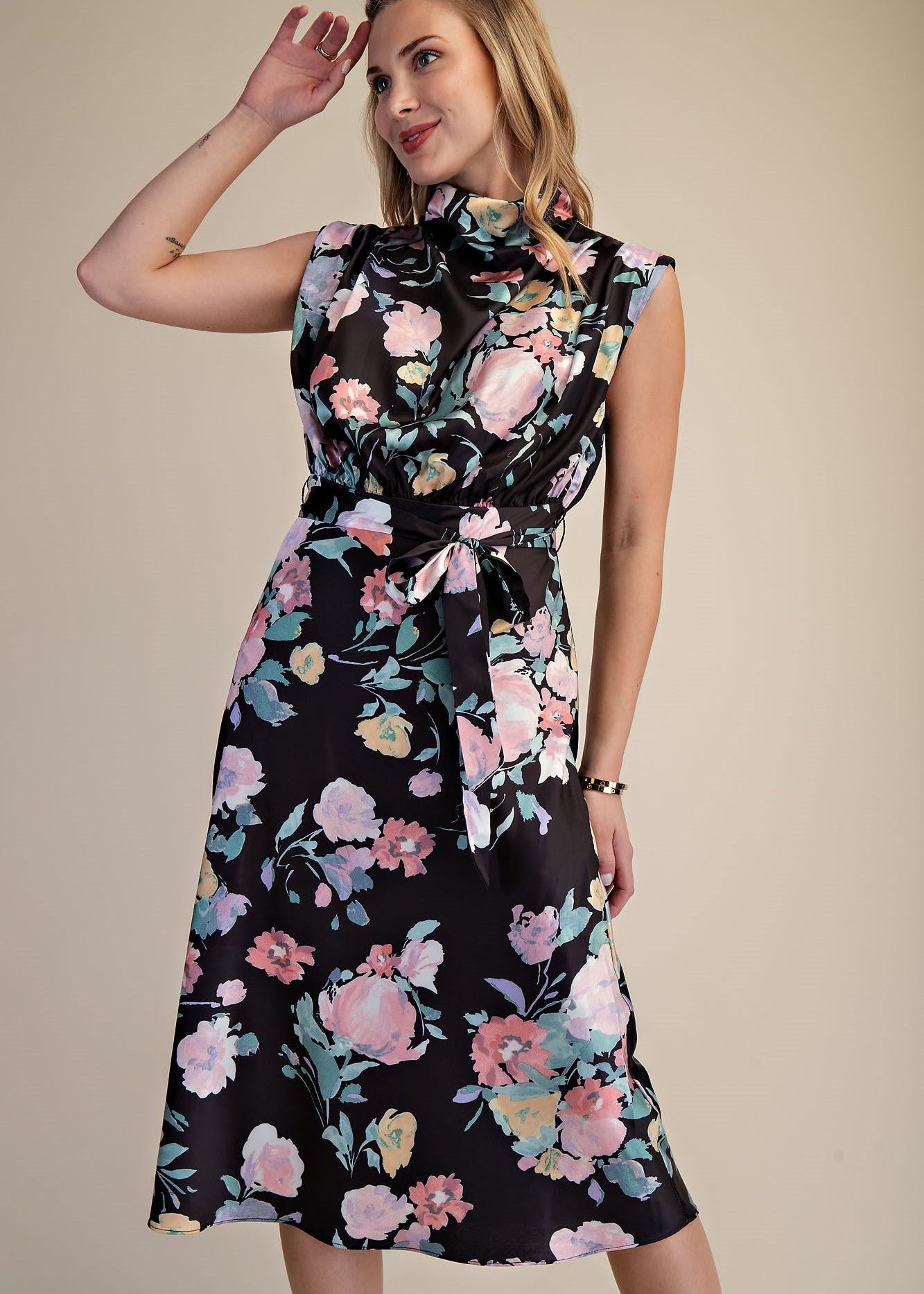 Woman wearing a floral dress against a beige background