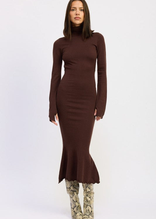 Woman wearing a brown long-sleeve dress with a fitted silhouette on a white background