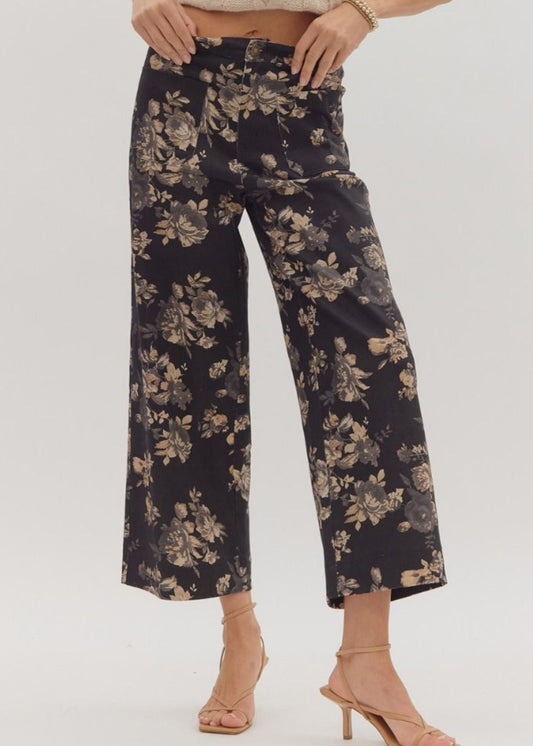 Woman wearing black floral pants on a white background
