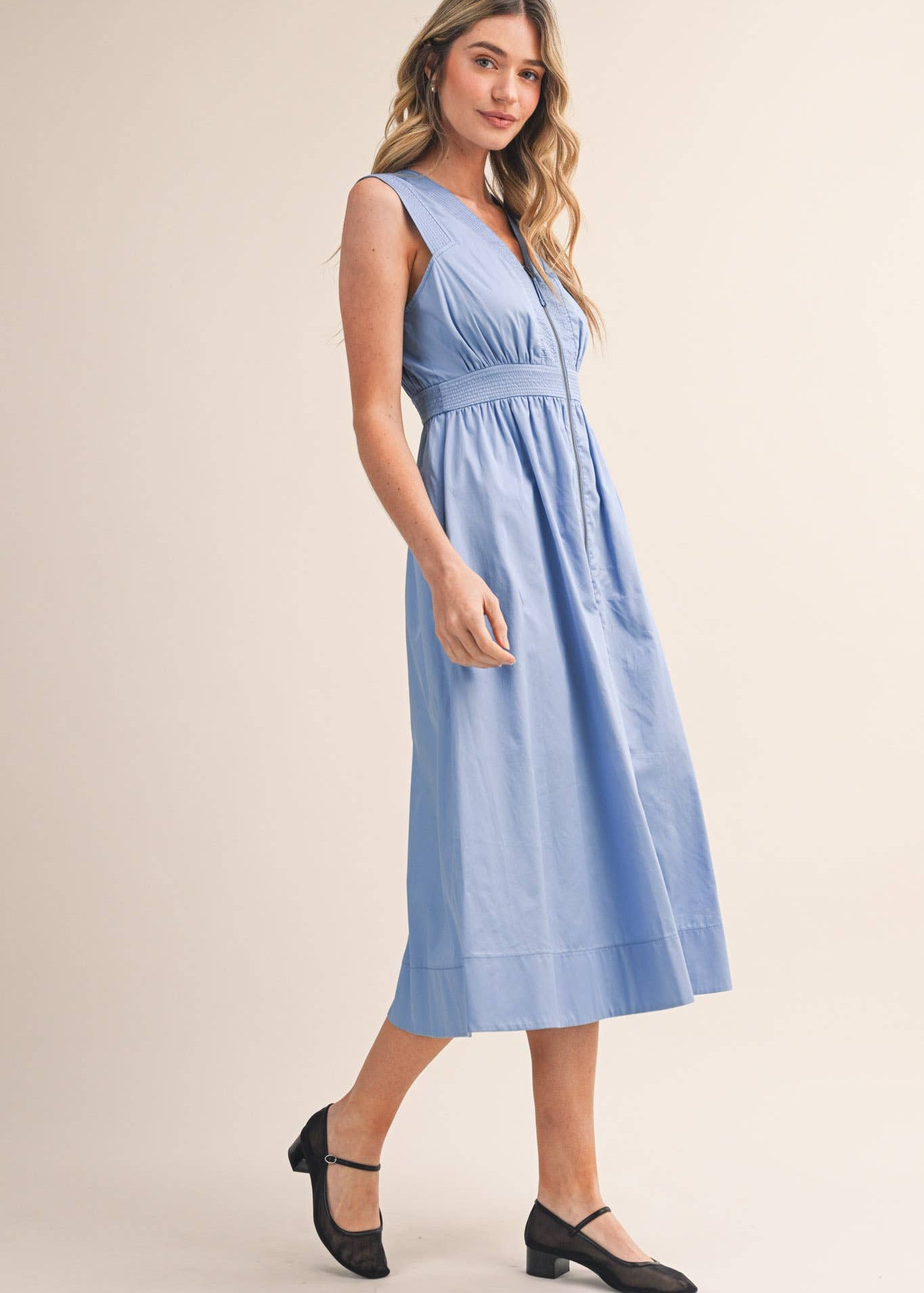 Women wearing blue dress side view
