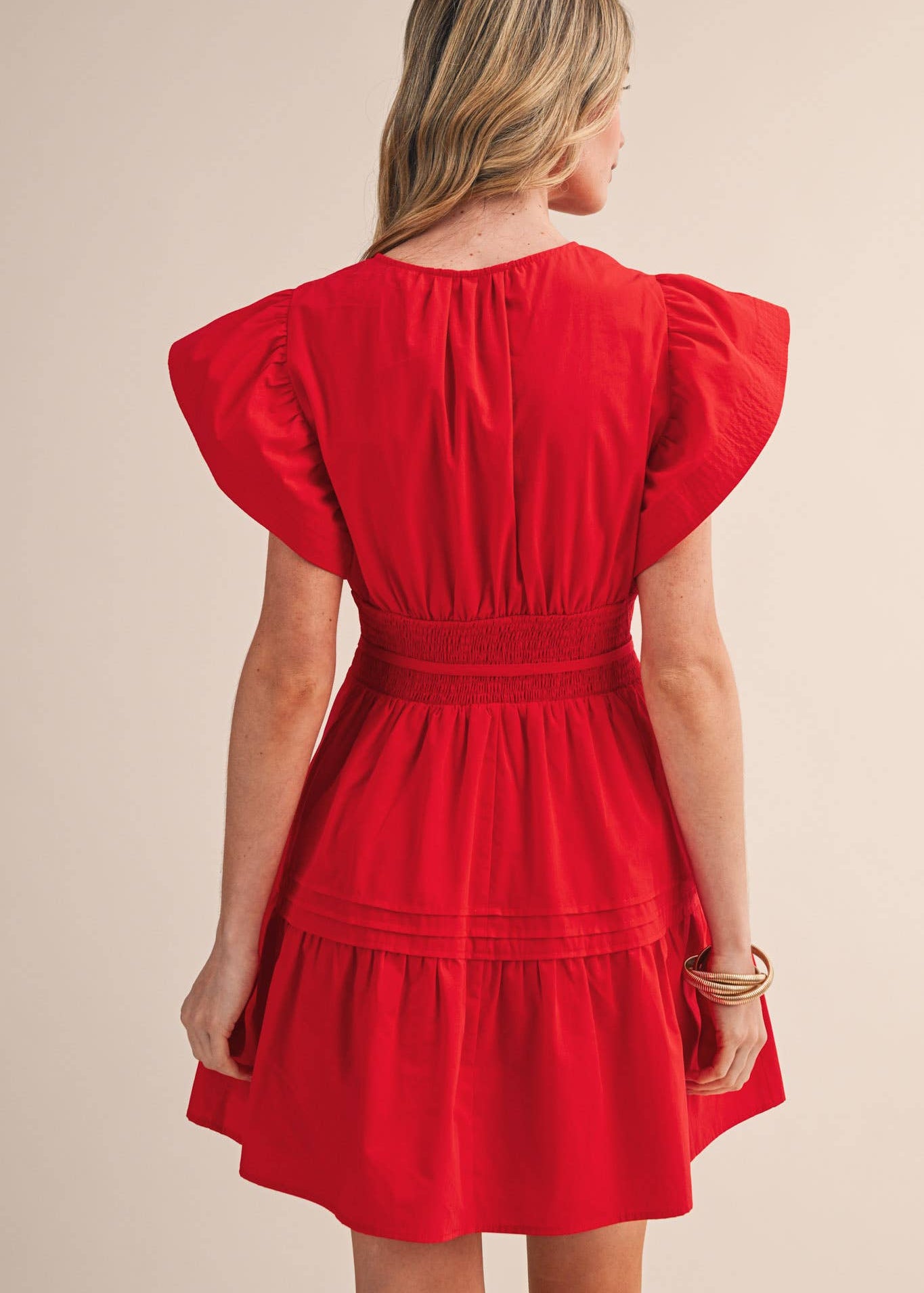 a view of women wearing red flutter sleeve mini dress
