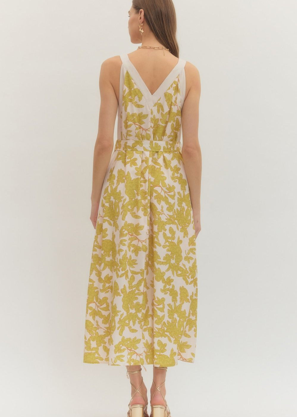 the backside of a women wearing a floral dress