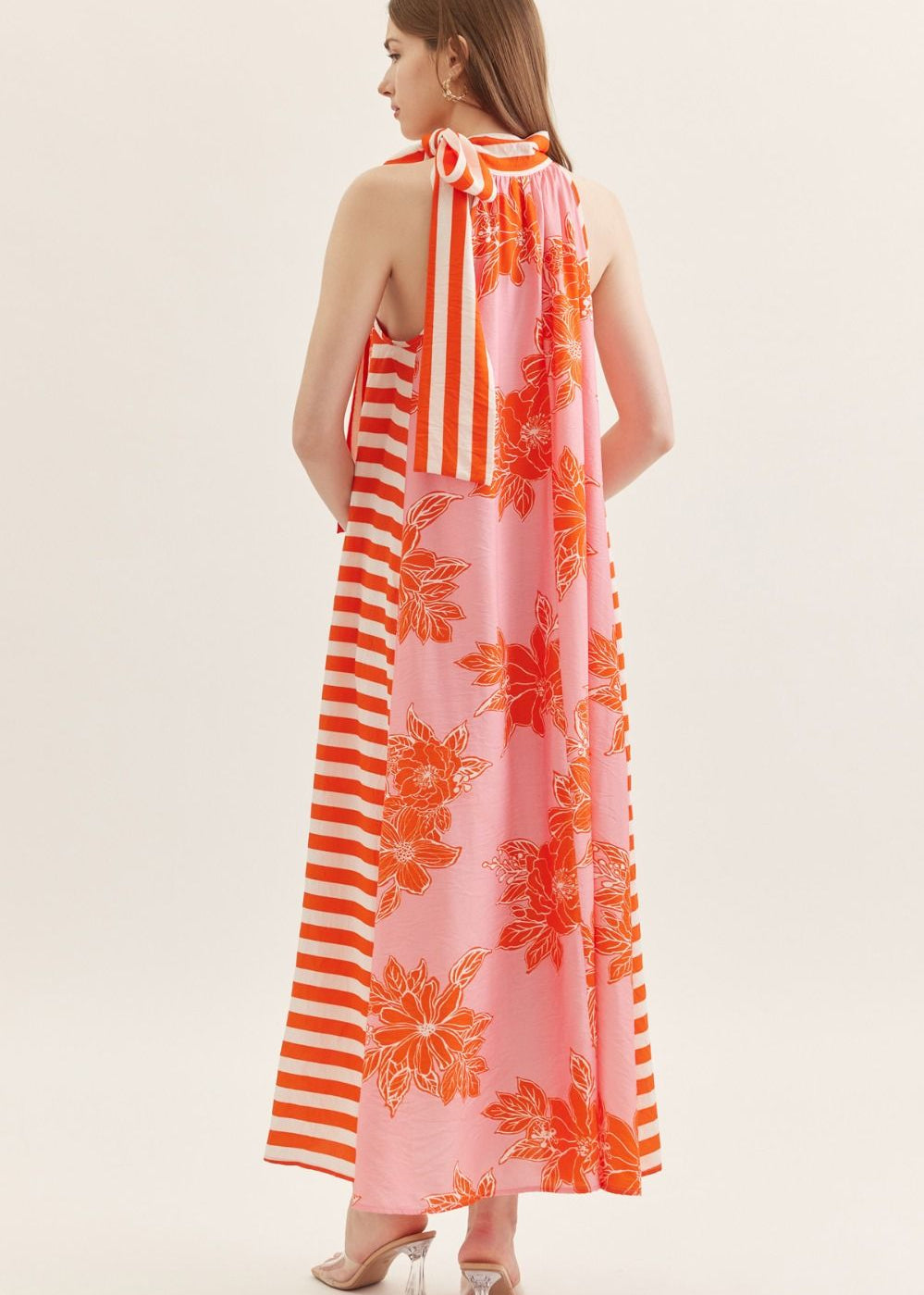 back view of womens floral orange and white dress
