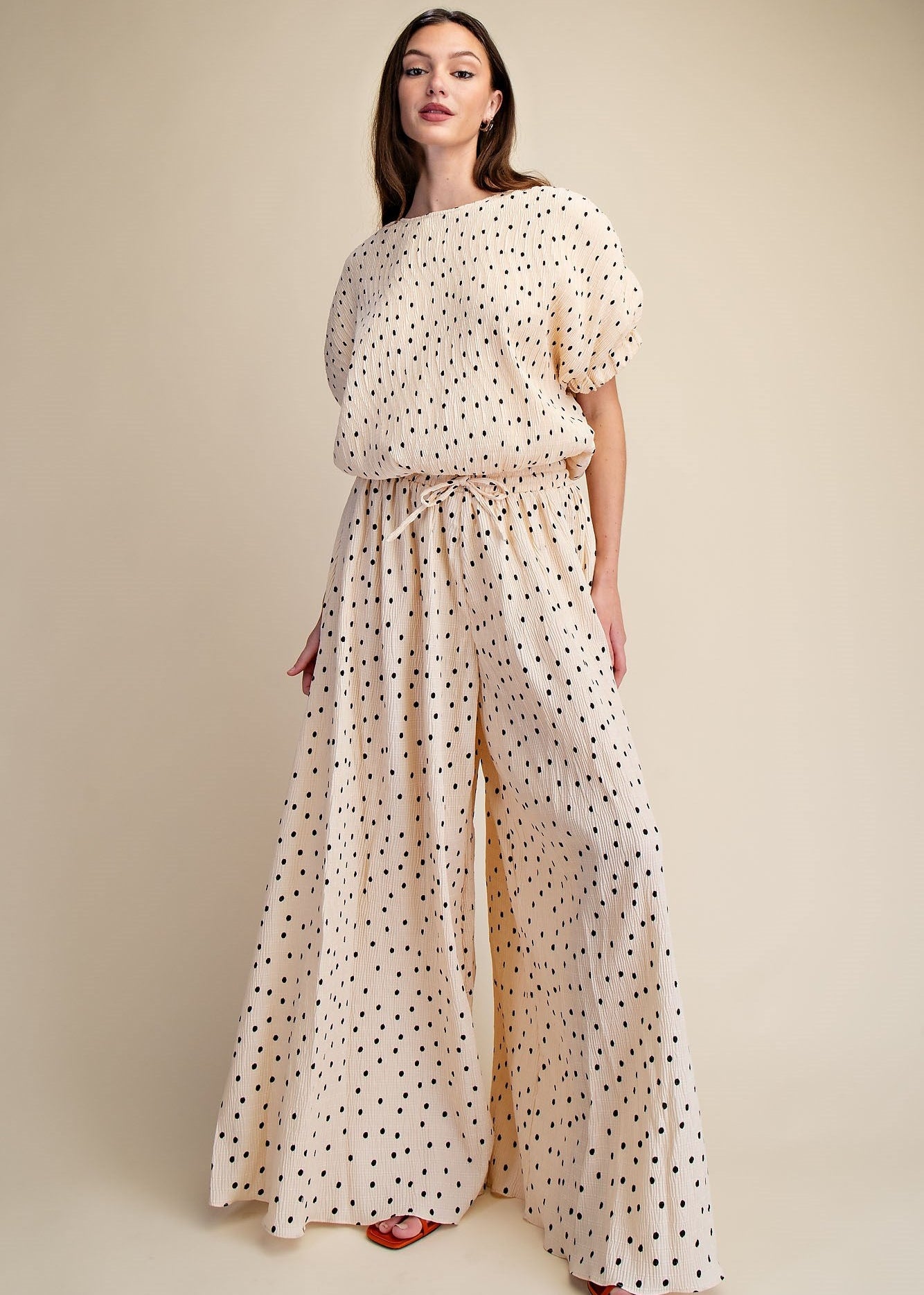 women wearing match blouse and wide leg pants in polka dot print