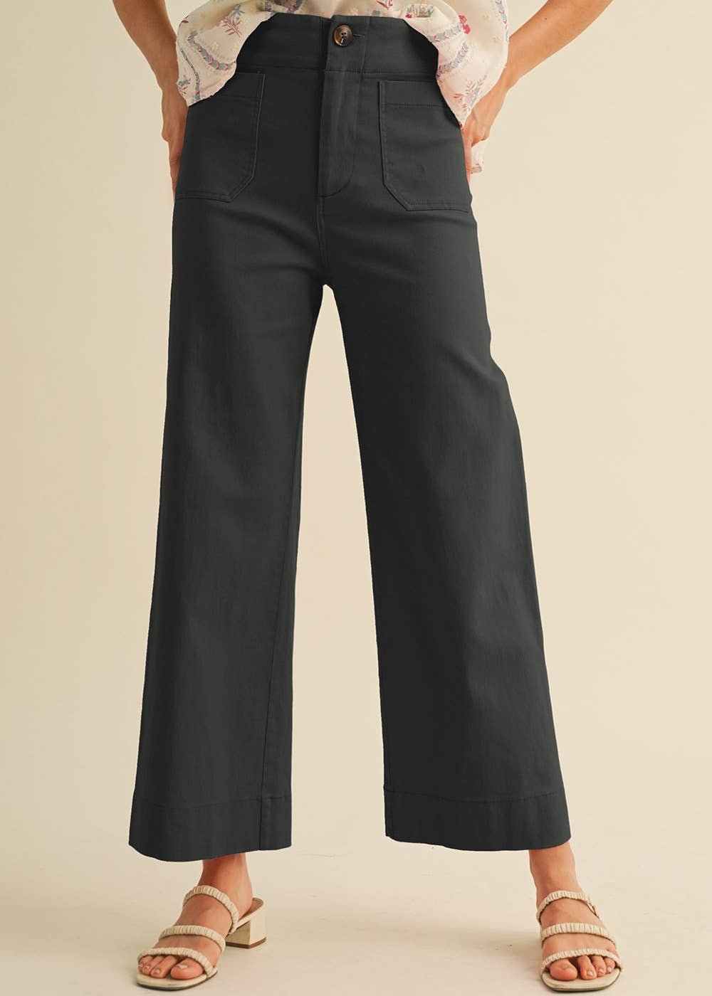 women wearing black pants with two pockets in front and strappy heals