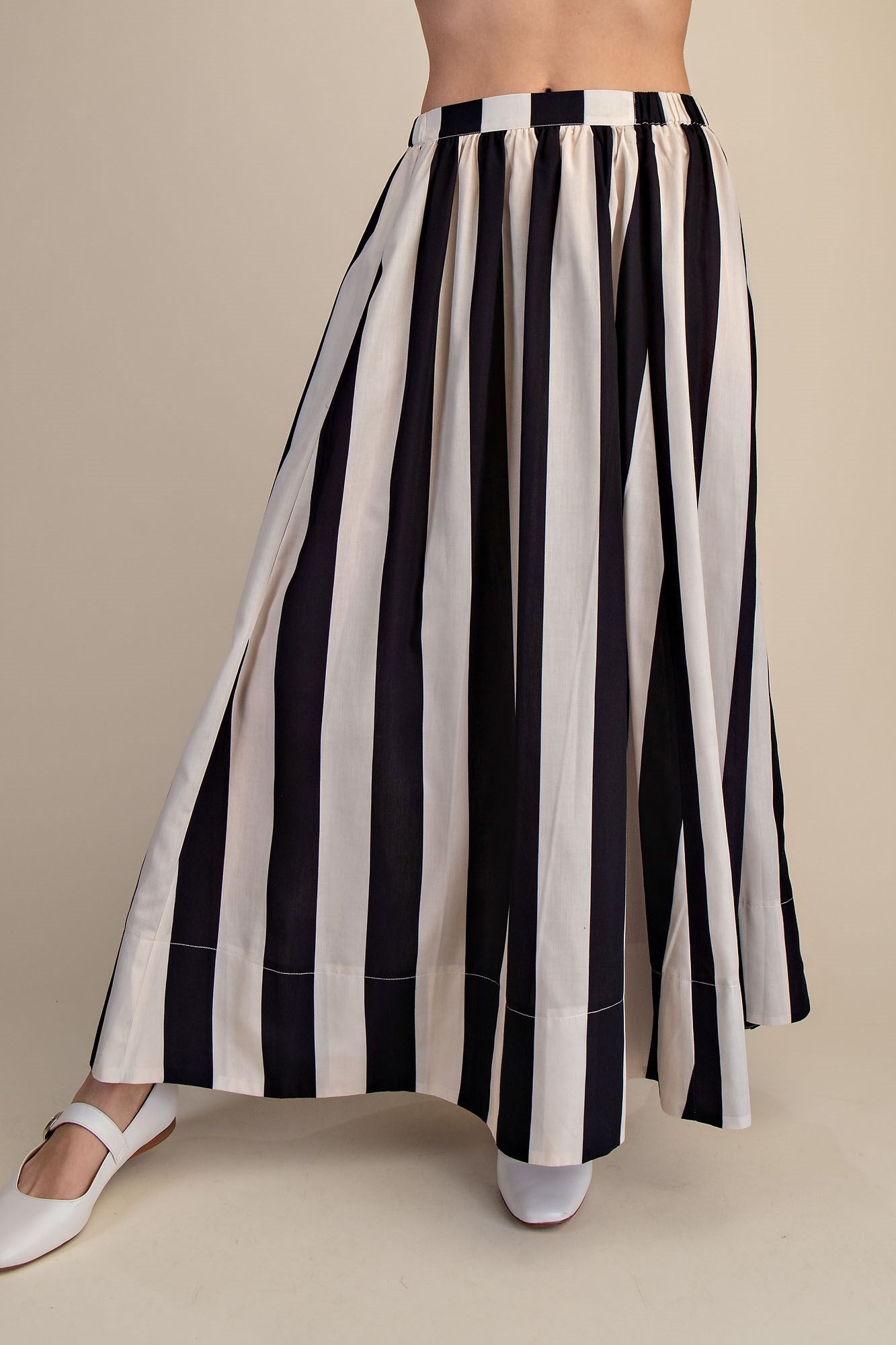 women wearing black and white striped maxi skirt 