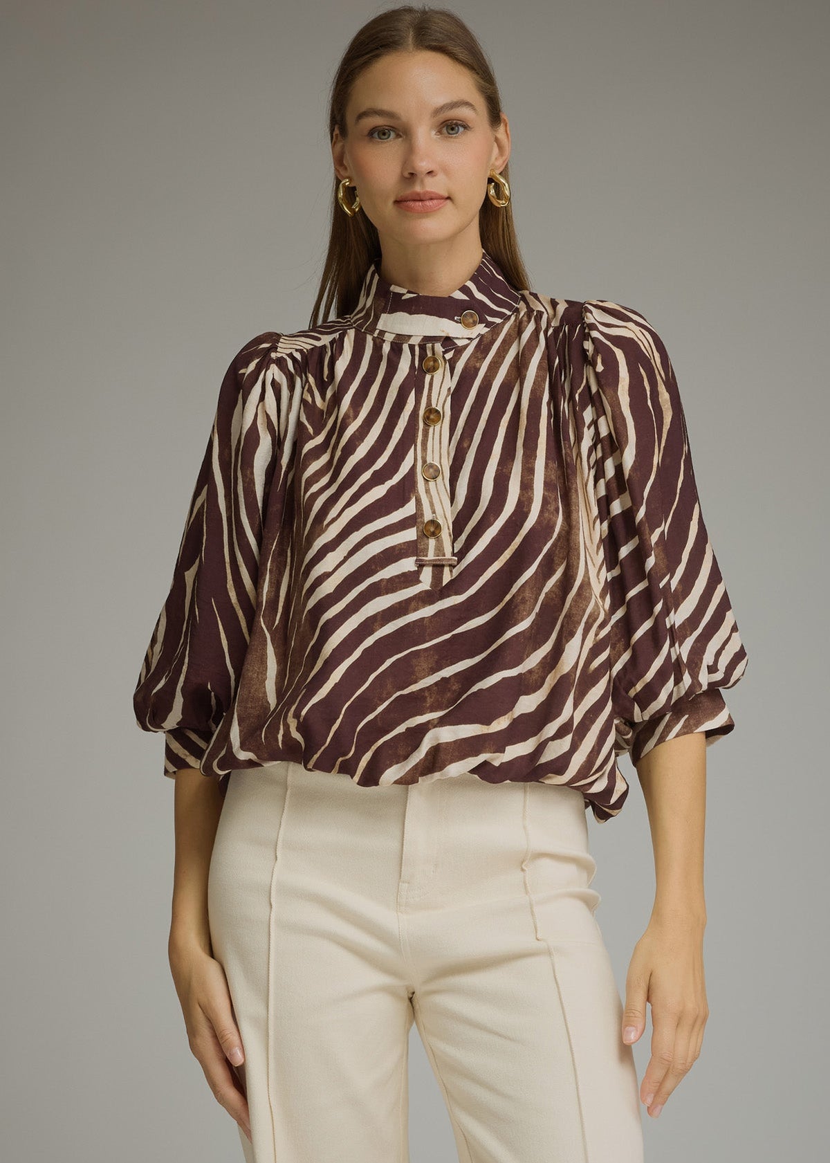 women wearing mocha zebra print blouse with ivory pants