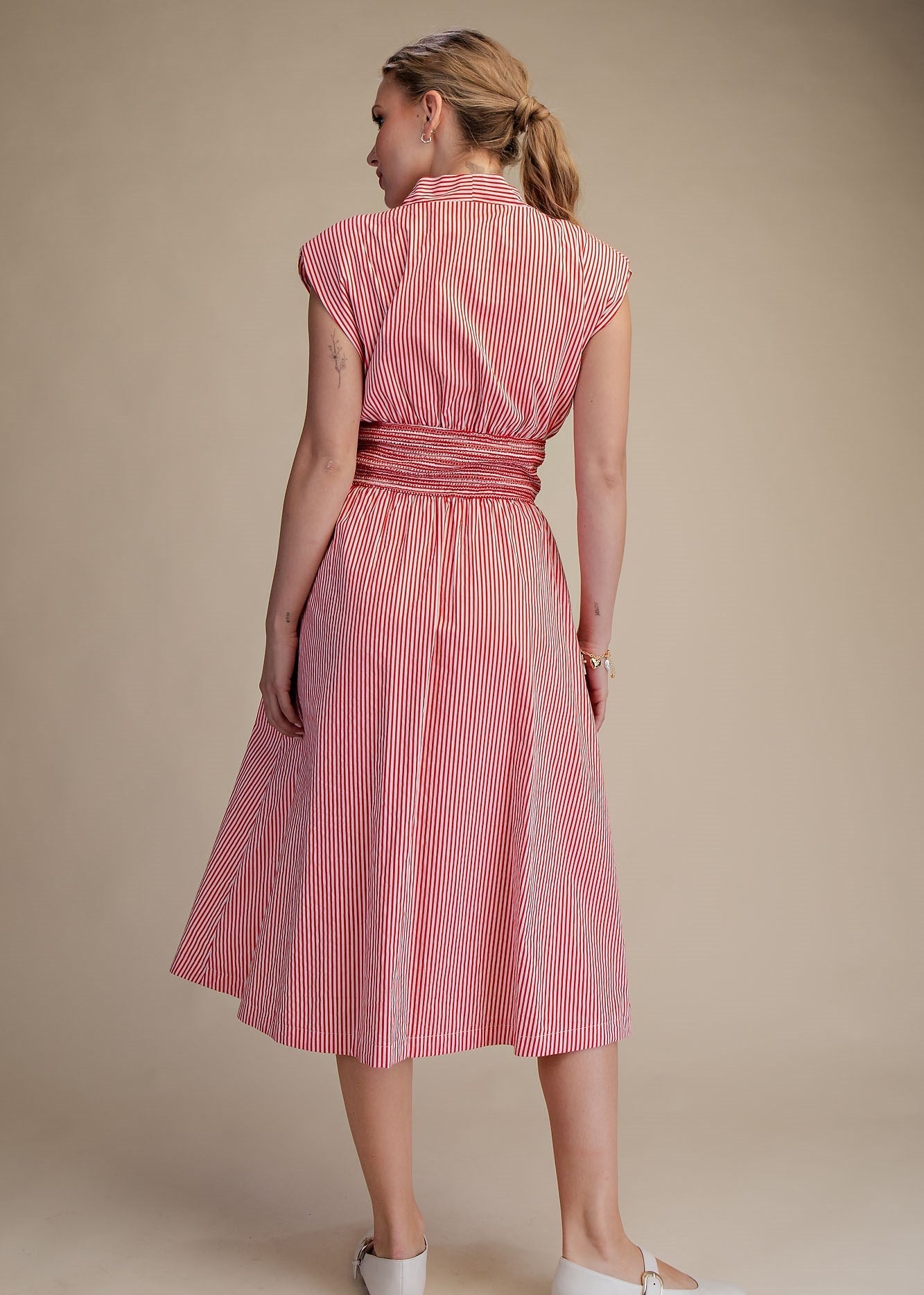 women wearing striped dress and showing the back of the dress