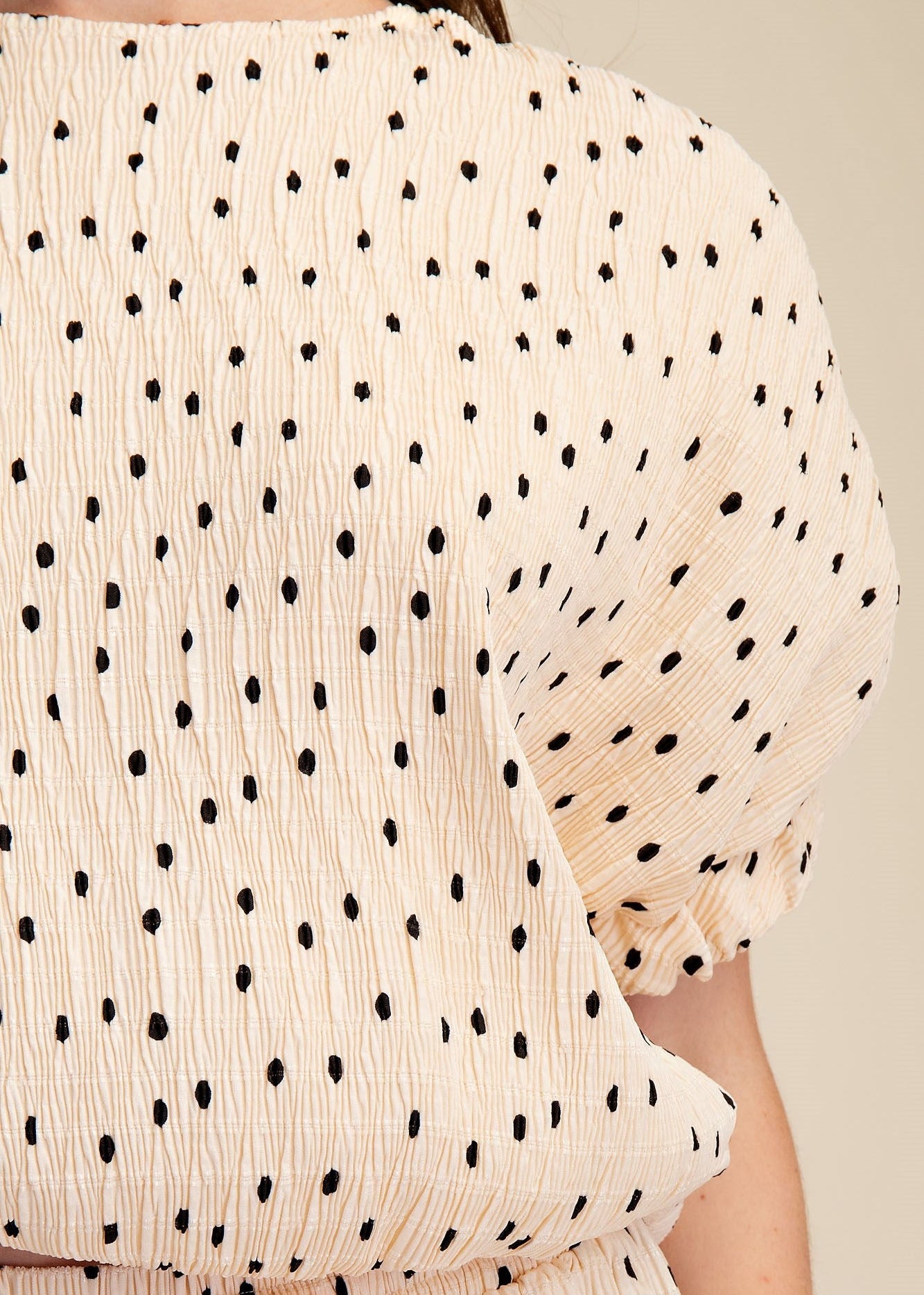 close up of textured polka dot womens blouse