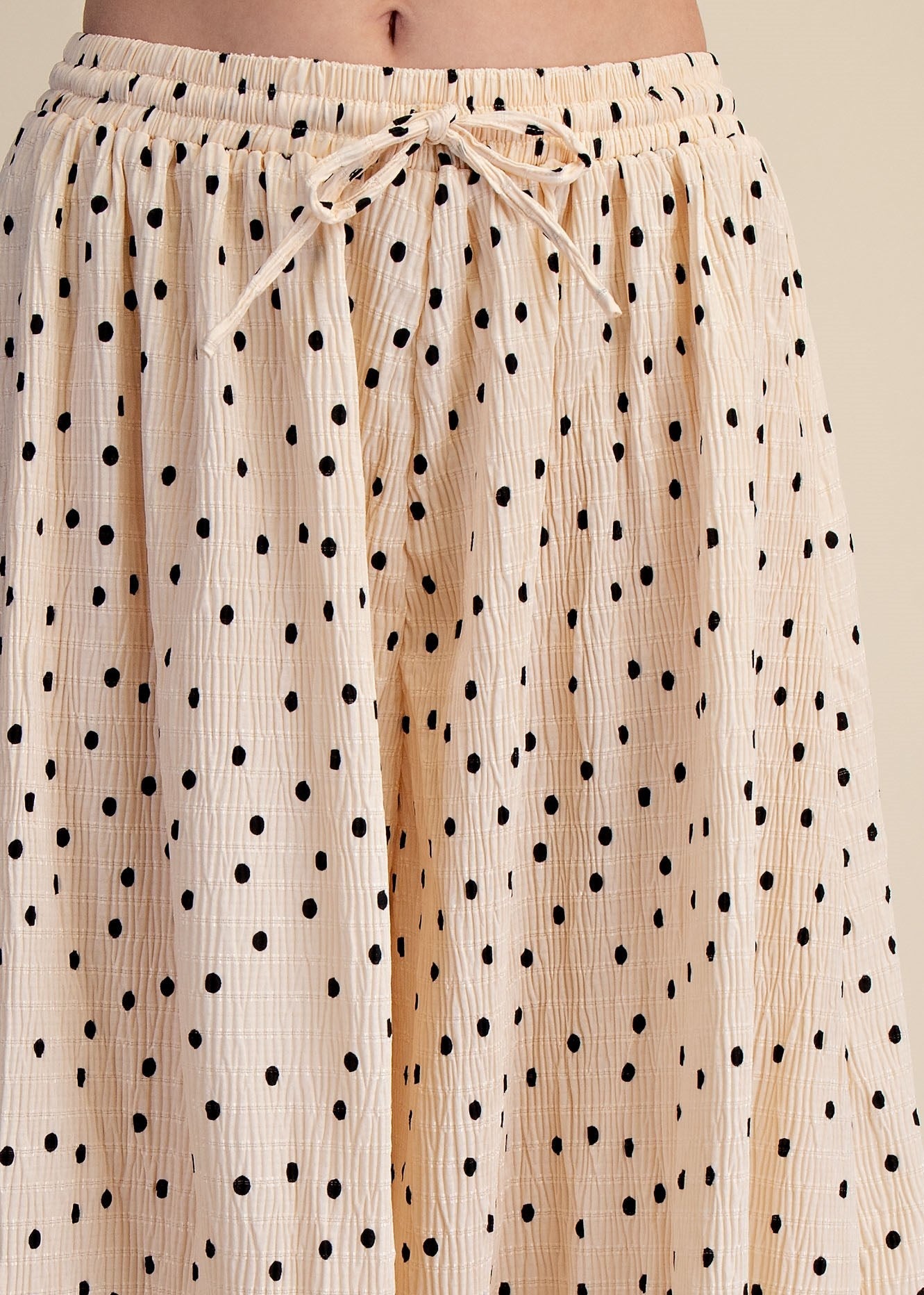 close up of drawstring polka dot pants