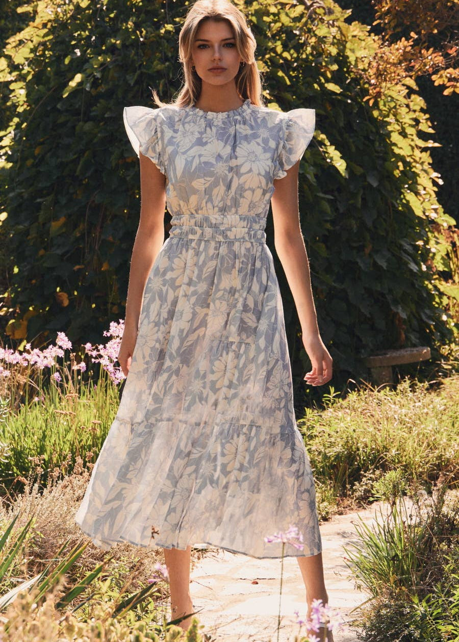 women wearing flutter sleeve dress in garden setting