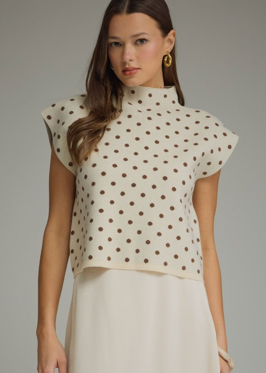 women wearing polka dot knit cap sleeve mock neck sweater
