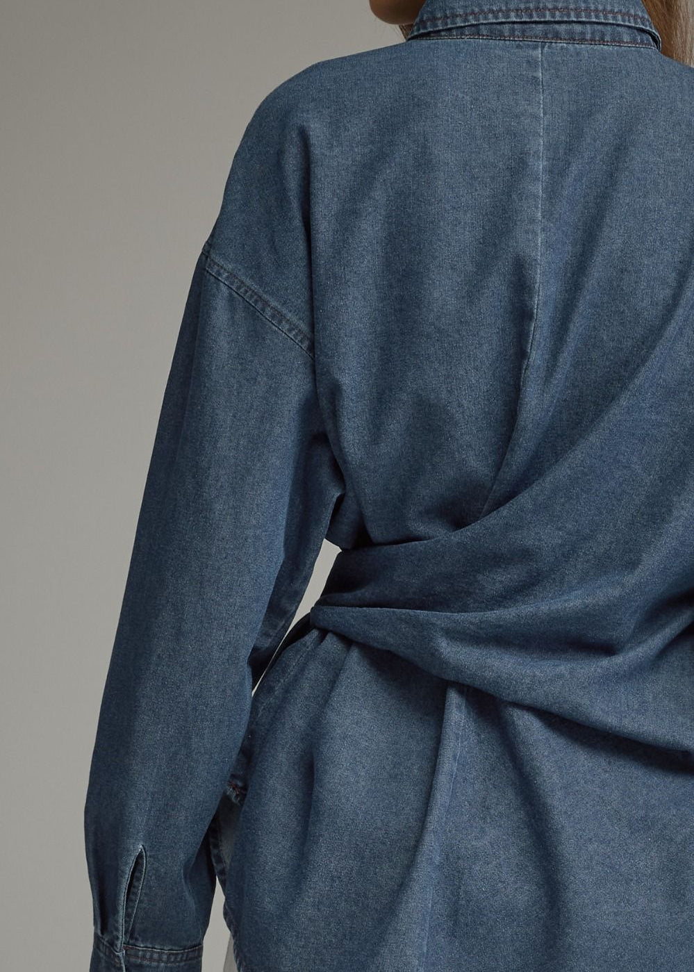 back of a denim collared shirt on a women