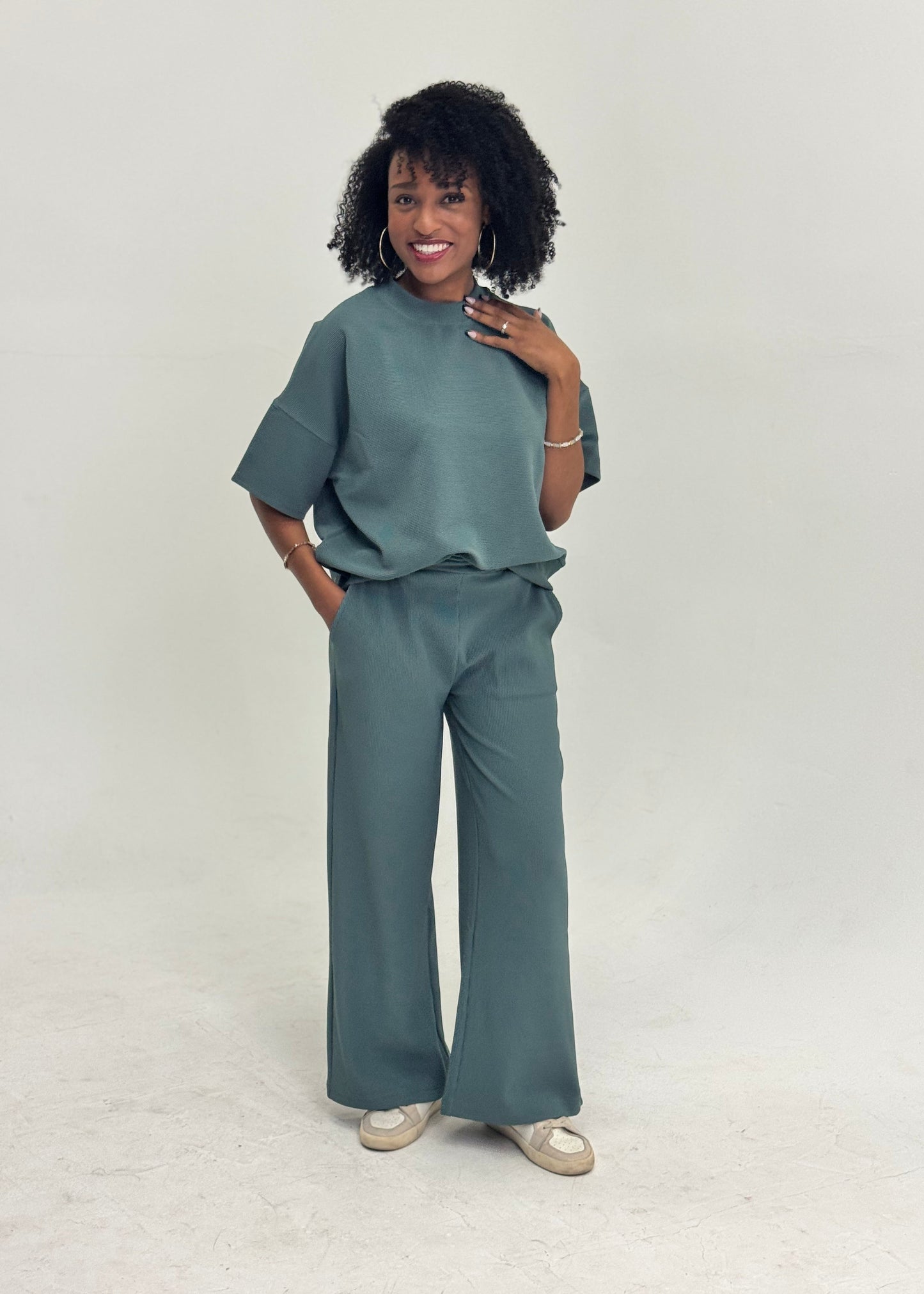 Women wearing a green rib knit matching set