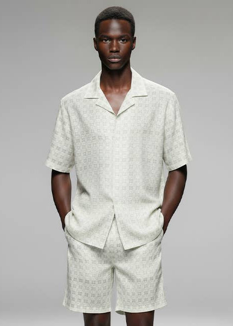 man wearing a white textrued shirt with matching shorts 