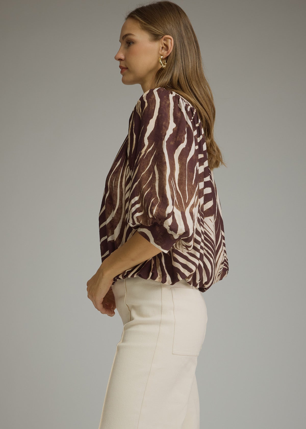 women wearing zebra blous side view of ballon cuffed sleeves