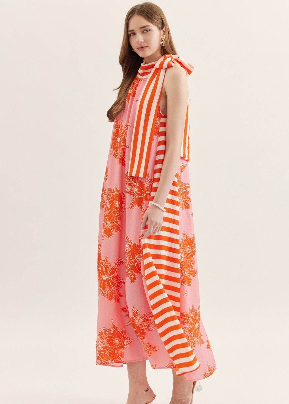side view of print sleeveless midi dress with self tie closure neck tie