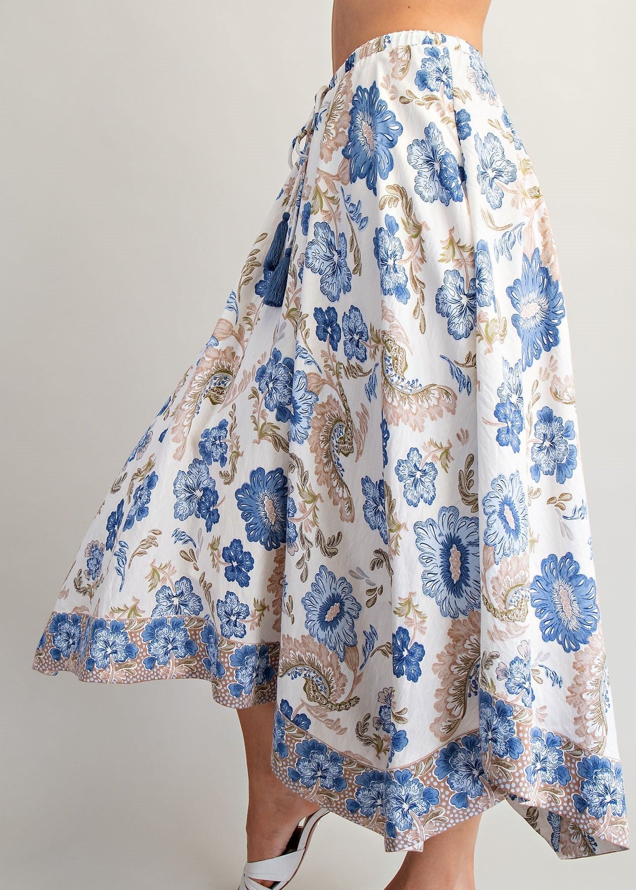 women wering paisley and floral print skirt