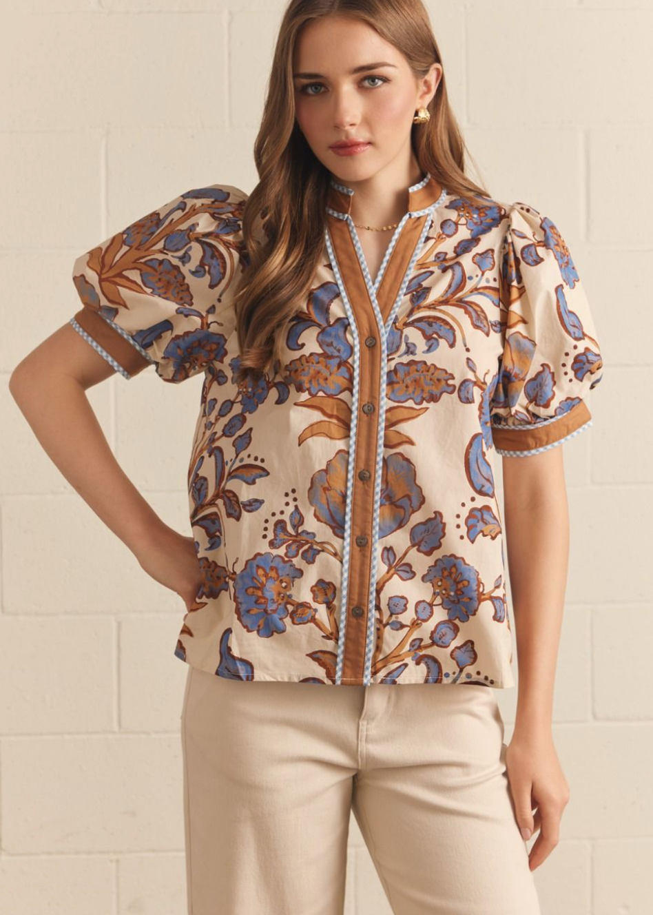 women wearing paisley print blouse with puff sleeves that are cuffed