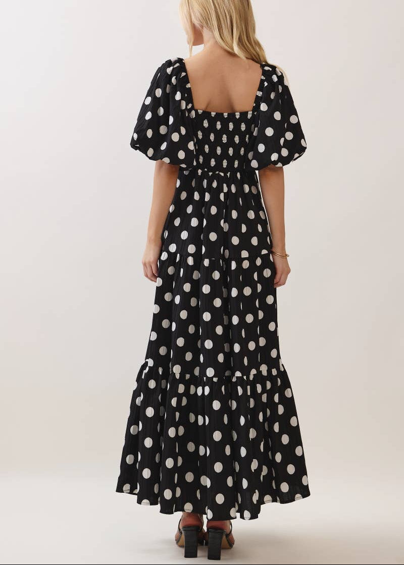 back of women wearing black and white polka dot dress