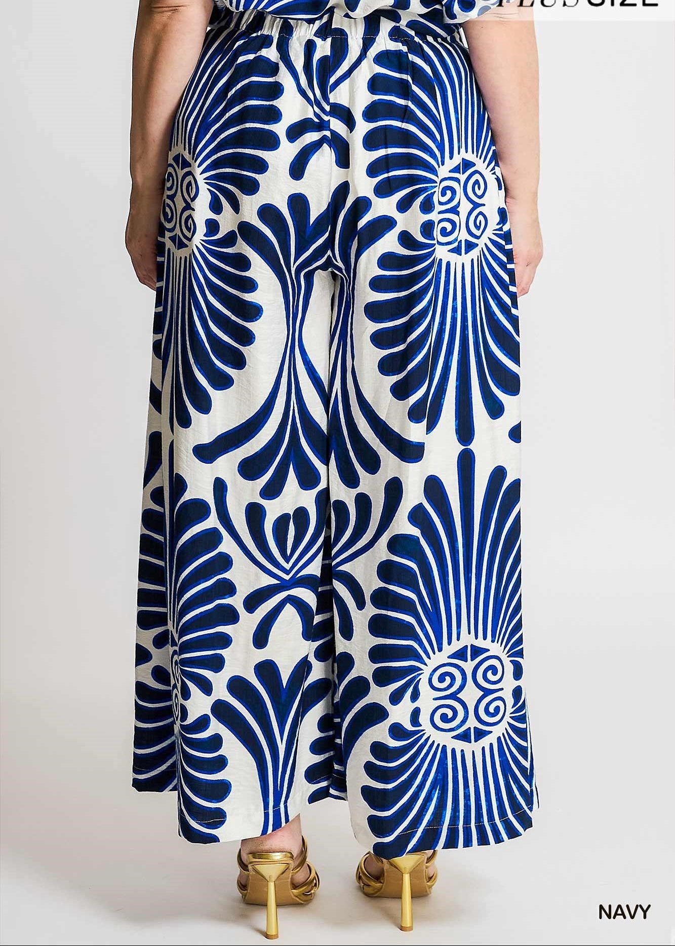 back side of women wearing printed blue and white wide leg pants