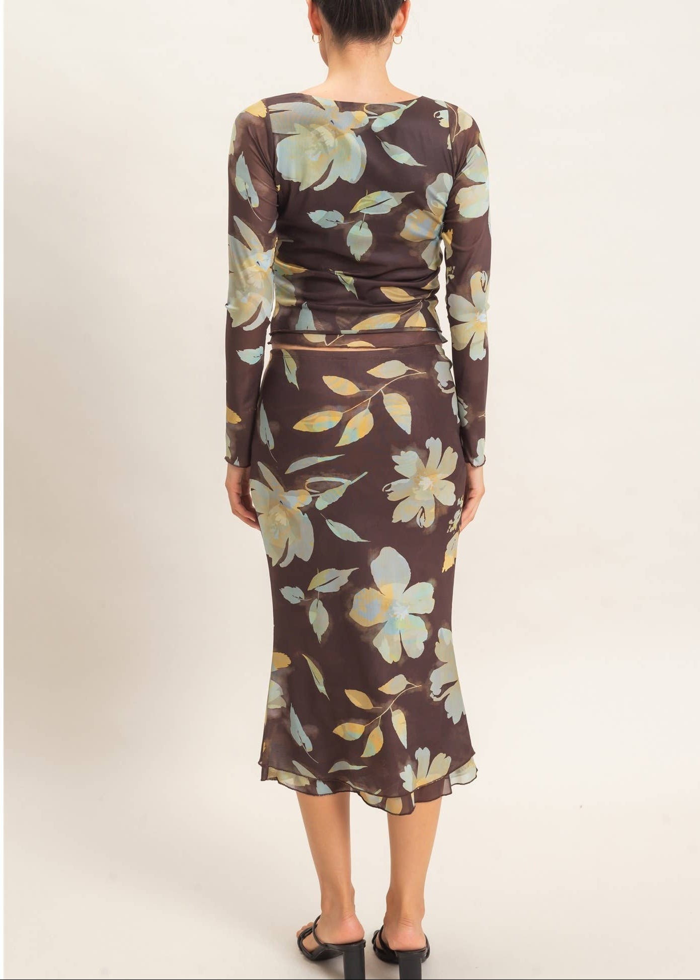 back of women wearing brown mesh floral skirt