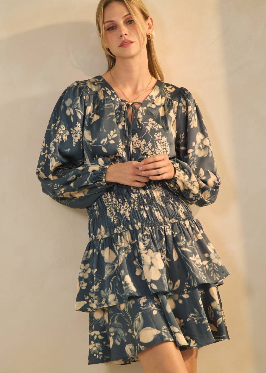 women wearing a floral printed smocked waist dress that hits above the knee