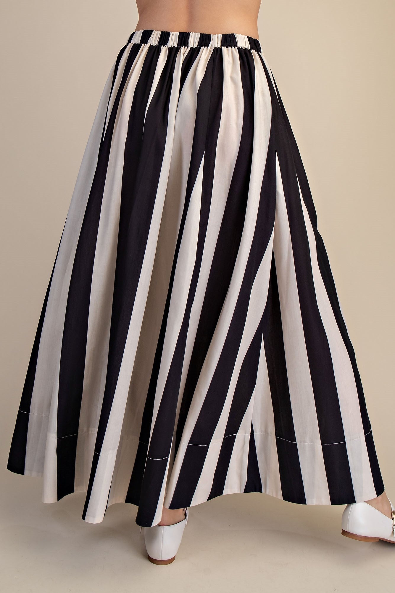 women wearing flowy striped black and white vertical stripes maxi length 