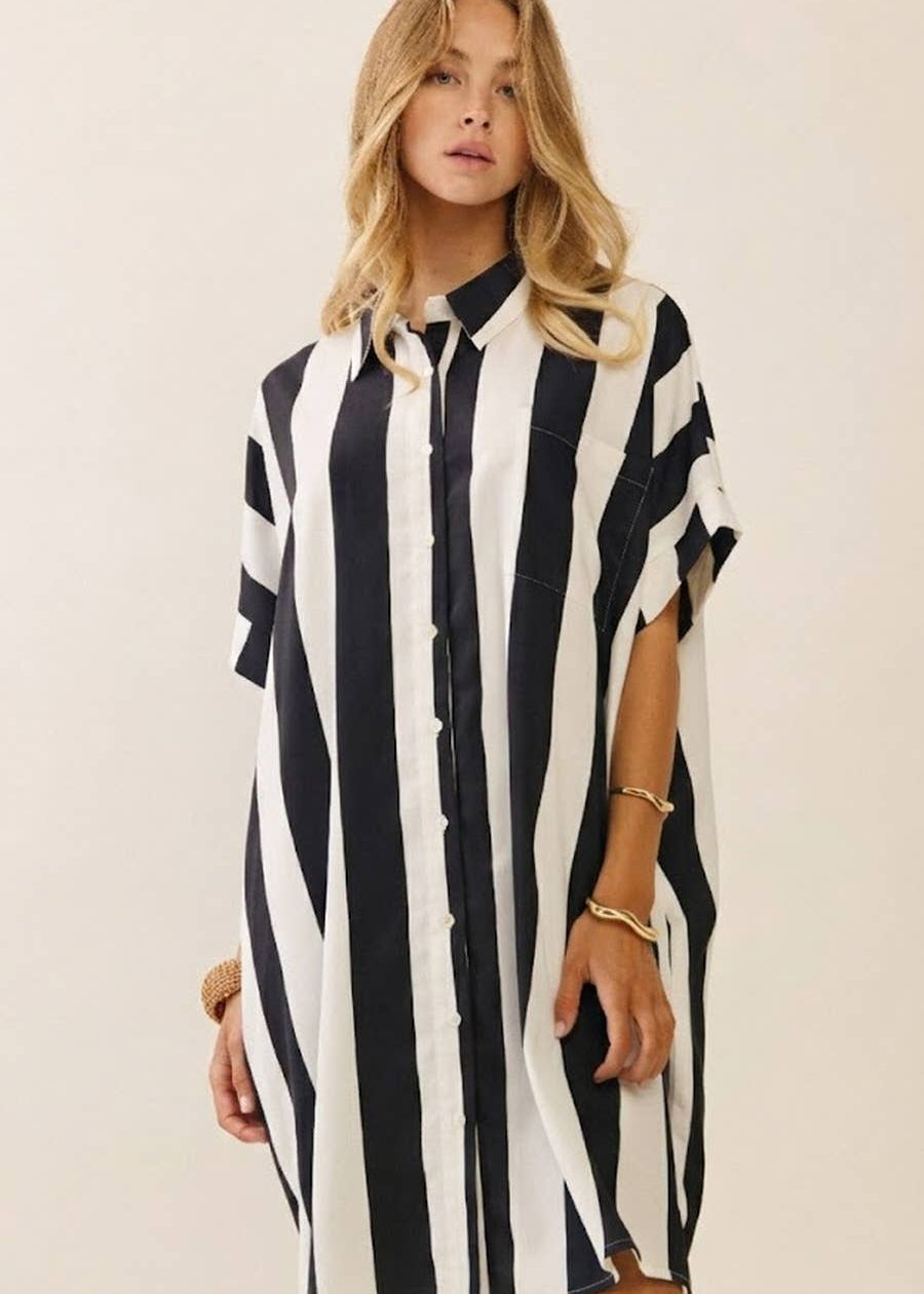 women wearing striped black and white collard dress shirt. Hits above the knee and is short sleeves.