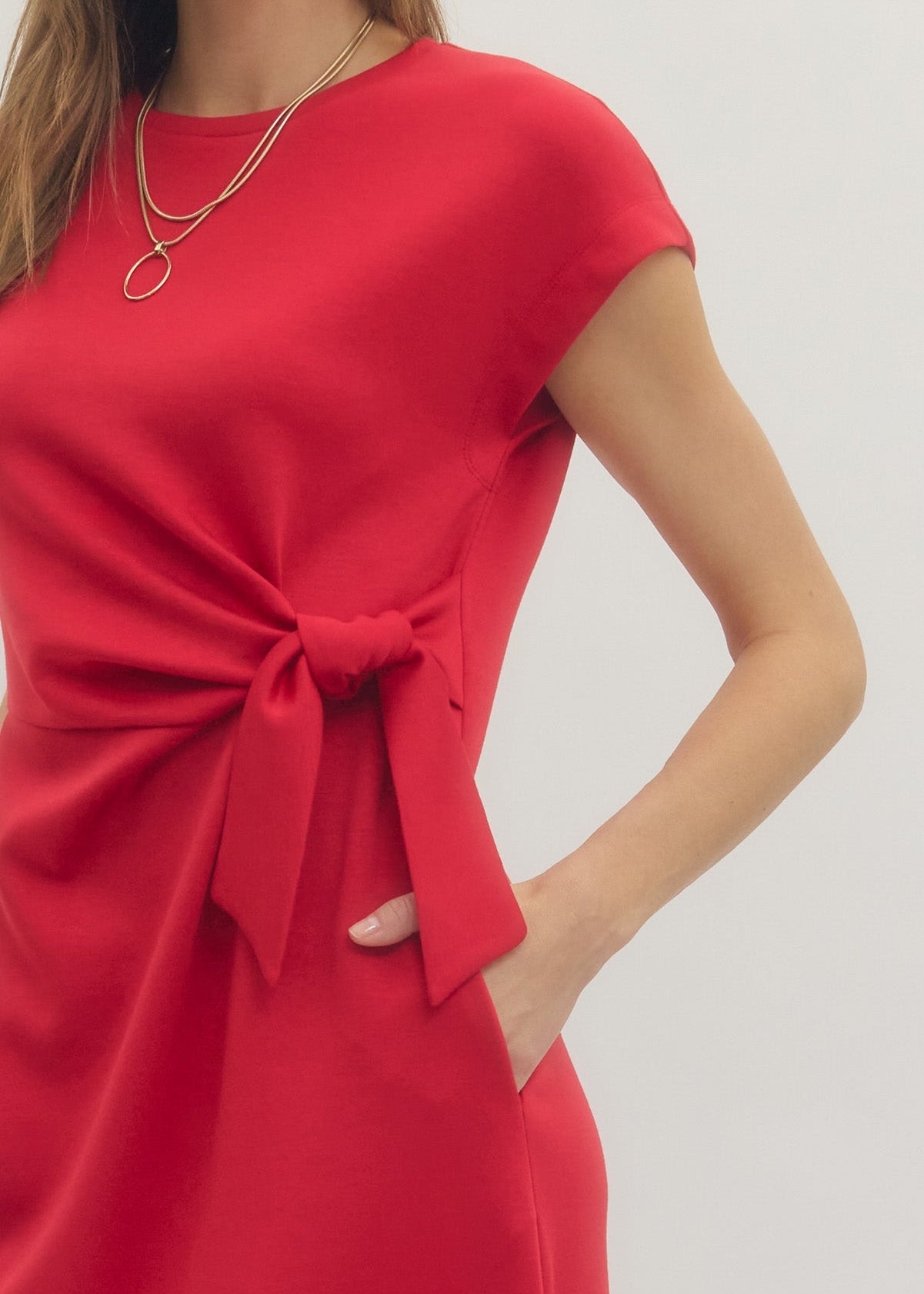 closeup of womens wearing cap sleeve red side tie dress