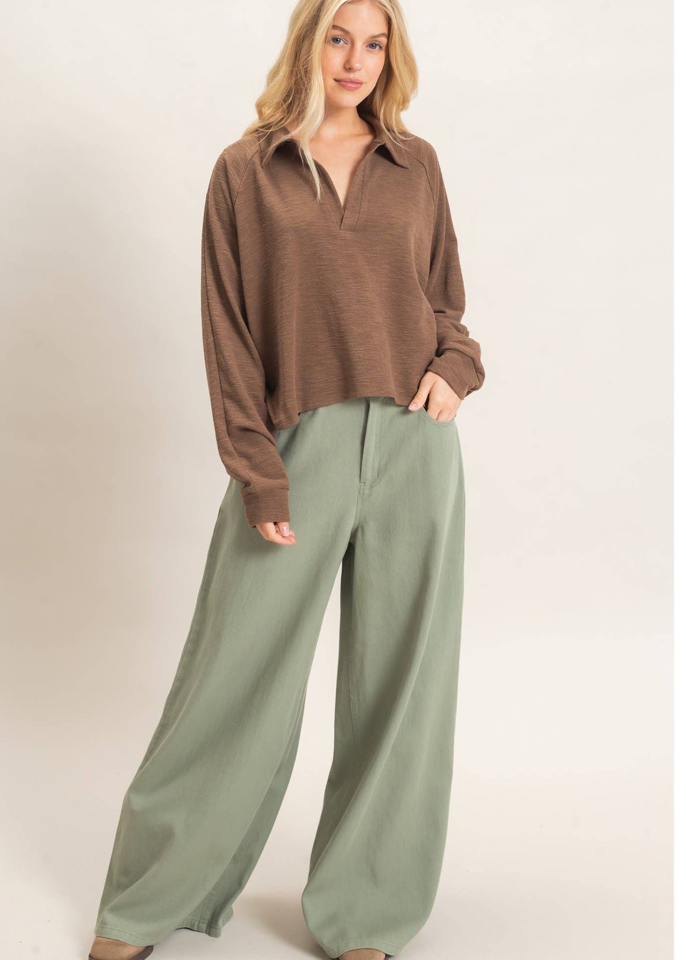 women wearing a brown sweater with wide leg relaxed trousers